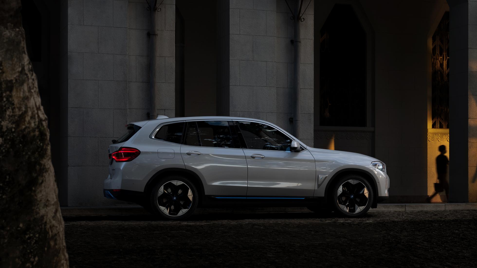 High-Power Charging BMW iX3 G08 side view at public charging station High-Power Charging BMW iX3 G08 2020 Mineral White metallic side view at public charging station