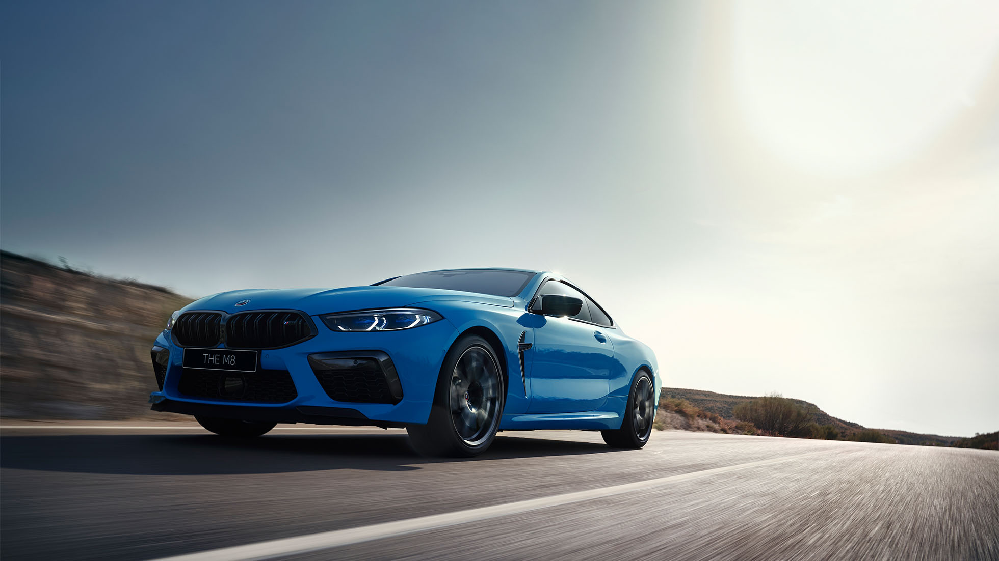 BMW M8 Competition Coupé. The first-ever BMW M8 Competition Coupé in Marina Bay Blue metallic, three-quarter front view.