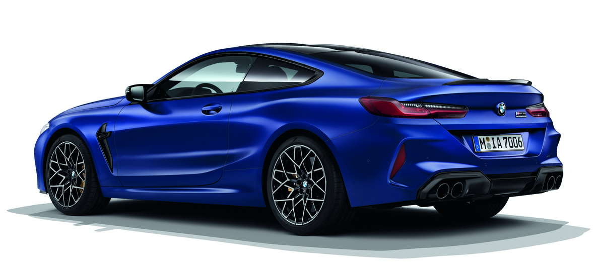 BMW M8 Coupé, three-quarter side view rear. BMW M8 Coupé in Frozen Dark Silver, three-quarter side view from rear.