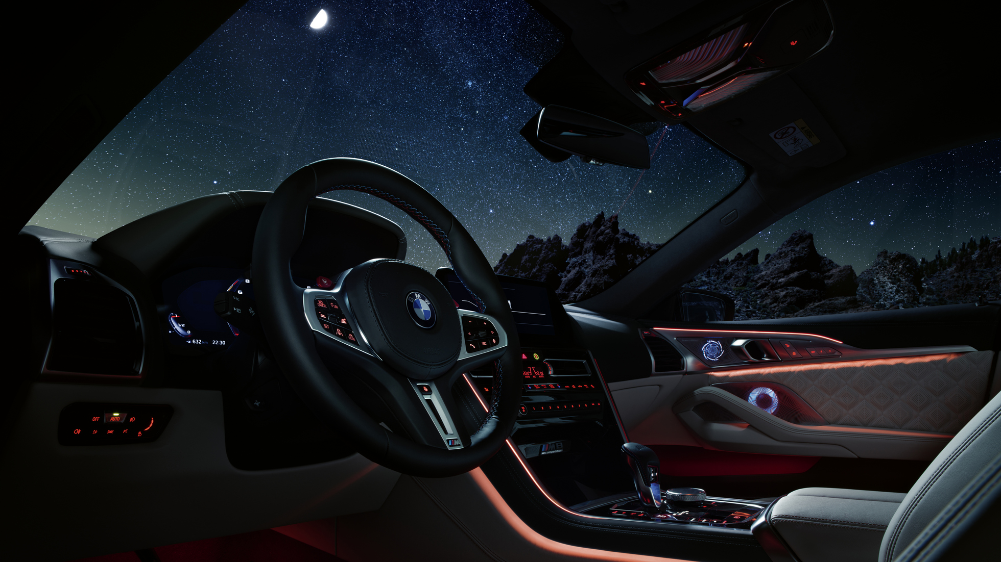 BMW M8 Competition Coupé, cockpit. BMW M8 Competition Coupé, cockpit at night with M leather steering wheel and blue ambient light.