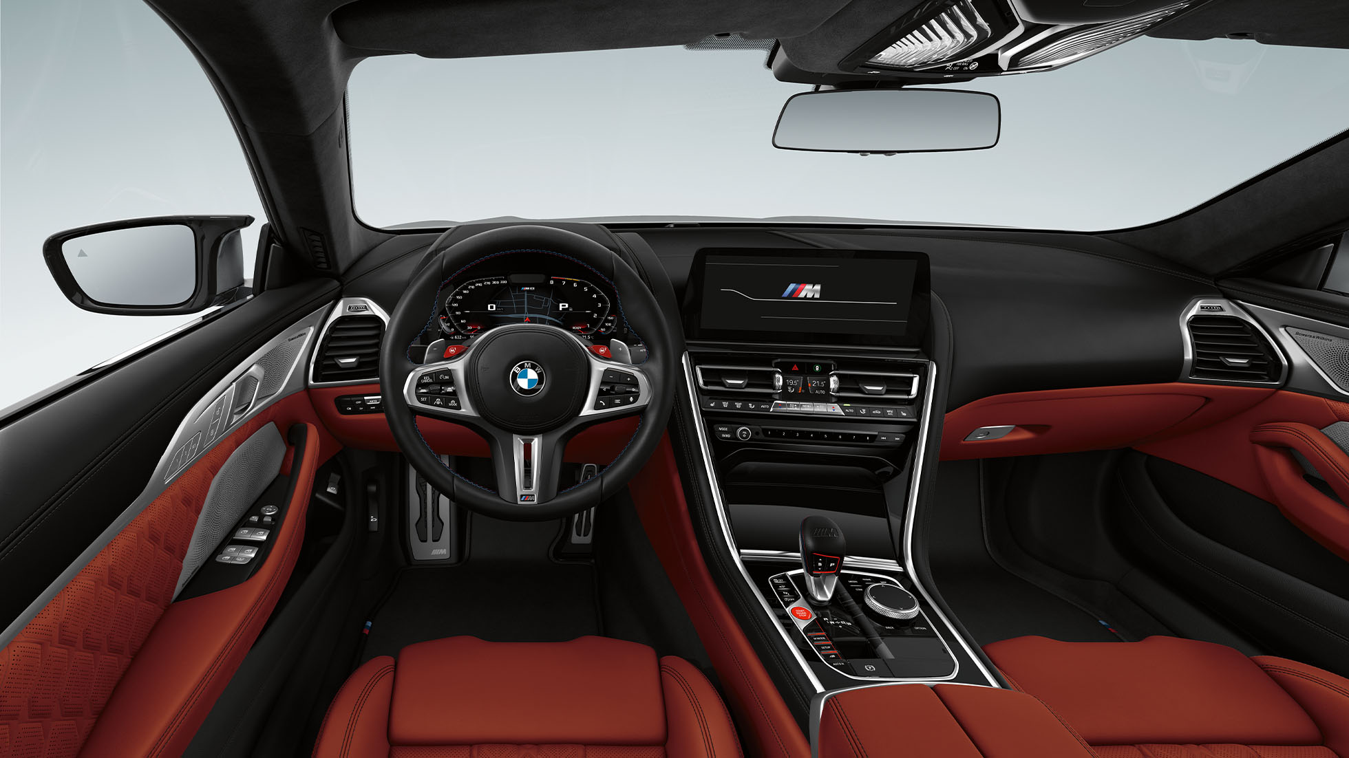 BMW M8 Competition Coupé, cockpit. BMW M8 Competition Coupé, cockpit at night with M leather steering wheel and blue ambient light.